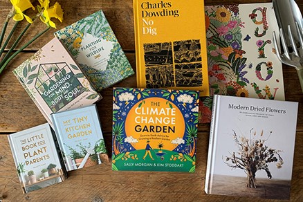 Selection of gardening books scattered on a table