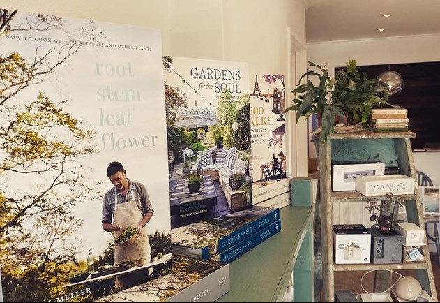 Books stacked on a shelf in a lifestyle shop setting