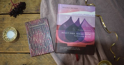 Pink-toned festive books on a table display